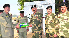 Pakistan Rangers Wing Commander Mohammed Ali (left) and BSF 94 Battalion Commandant GS Dhaliwal exchange sweets in the RS Pura sector on Sunday.
