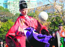 Wearing ancient Japanese costumes, participants play kemari, a ball-lifting game which came from China in the 7th century, using only their right legs in Tokyo on Sunday