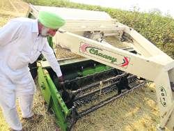 Darshan Sidhu with his machine that disposes of paddy stubble at Rampura village in Bathinda on Monday.