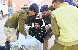 The police take away SAD councillor Malkiat Singh, who was protesting outside the MC Commissioners office in Sector 17, Chandigarh, on Monday. A Tribune photograph