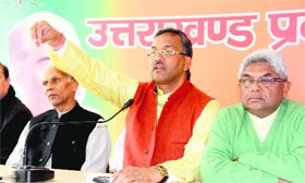 Trivendra Singh Rawat, national secreary of the BJP, addresses mediapersons in Dehradun on Monday.