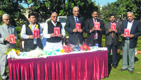 Uttarakhand Speaker Govind Singh Kunjwal releases a book titled "Shadows of Terror and Other Stories" by Sanjeev K Sharma in Dehradun on Sunday.