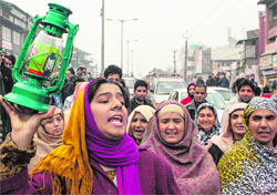Women raising slogans against the Power Development Department at Lal Chowk on Monday. Tribune Photo: Yawar Kabil