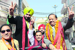 BJP CM candidate Harsh Vardhan campaigns with party leader Navjot Singh Sidhu at Krishna Nagar in East Delhi on Monday.