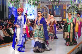 Pakistani models present creations by designer Zahid Khan at a bridal couture week in Lahore on Sunday