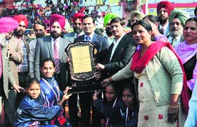Deputy Commissioner Kamal Kishore Yadav with a winning team during the closing ceremony of the National School Games in Bathinda on Tuesday