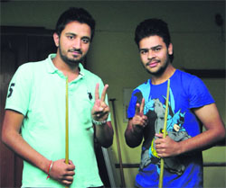 Rajwinder Brar (right) and Tanurag Gautam in a jubilant mood after winning the titles in the Chandigarh State Billiards and Snooker Championship.