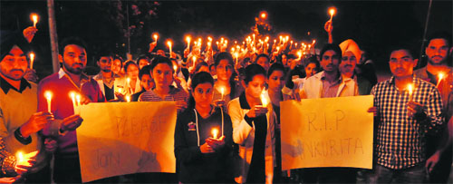 Students take out a candle-light march in Chandigarh on Tuesday.