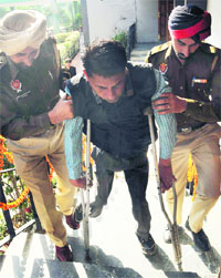 In the absence of a ramp at the venue of a function, police officials help a physically challenged person climb stairs, in Mohali on Tuesday.
