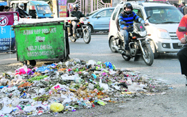 Garbage heaps lying on roads in Dehradun on Tuesday. 