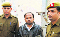 Accused Vedender, who fired three bullets on director Ashish Dahiya, being escorted by the police.
