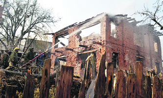 Firemen douse the blaze in a house after the gun battle in Kupwara on Tuesday.