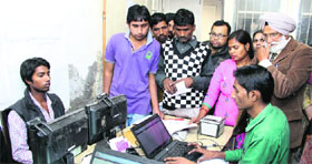 Aadhaar card applicants at the District Administrative Complex in Jalandhar on Tuesday.