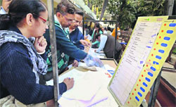 Officials inspect poll material prior to heading to various booths in New Delhi on Tuesday.  PTI