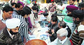 Municipal Corporation employees hold a property tax awareness-cum-realisation camp at the IDH Market in Amritsar