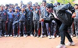 Athlete PT Usha shows students how to get off the block in Phase IV, Mohali, on Wednesday