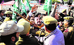 Activists of the People Democratic Party hold a protest against the Power Development Department for imposing long power cuts in Jammu