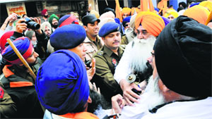 Police personnel argue with members of a radical Sikh outfit outside the Golden Temple in Amritsar on Wednesday