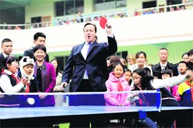 Having a ball: British Prime Minister David Cameron plays table tennis during his visit to a school in China's Sichuan province on Wednesday
