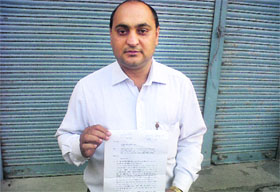 Parminder Singh shows the RTI document in support of his claim in Bathinda on Thursday.