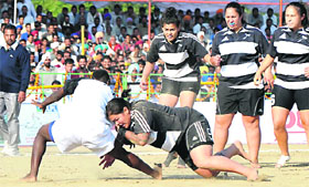 A stopper of the New Zealand team (right) grasps a raider of Kenya during a match of the ongoing World Cup Kabaddi at Doda in Muktsar on Thursday.