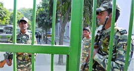Security personnel guard the counting centre at N.P. Bengali Senior Secondary School, Gole Market, in New Delhi on Thursday.