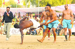 A Kenyan raider tries to wriggle free from the grip of an Indian player during their match in the World Cup Kabaddi on Thursday.