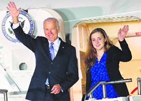 US Vice President Joe Biden along with his granddaughter Finnegan Biden waves upon his arrival at Seoul on Thursday