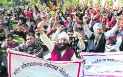 Members of the Ministerial Services Association hold a protest during a pen-down strike in Bathinda on Friday. Tribune photo