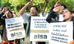The students of Jawaharlal Nehru University shout slogans during a demonstration at Jantar Mantar in New Delhi on Friday, demanding action on all the pending cases of communal violence. 
