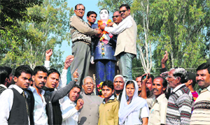 People pay floral tributes at the statue of BR Ambedkar on his death anniversary at Jwalapur in Haridwar on Friday.
