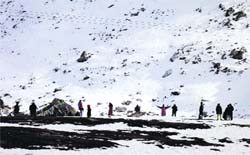 Tourist enjoy at a snow point on the way to Rohtang Pass on Friday. Photo: MC Thakur