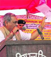 Former Union minister and sitting Congress MLA Venod Sharma addresses a public function at Kiloi in Rohtak district on Friday.