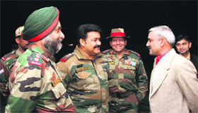 Actor Mohanlal (second from left) interacts with Army officers during his visit to the LoC.