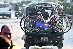 Beneficiaries of the Mai Bhago Scheme take cycles back home after their distribution in school in Jalandhar on Friday
