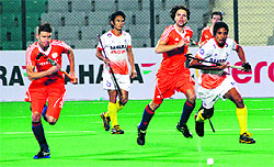India and the Netherlands players vying for the control of the ball during their opening contest at the World Cup in New Delhi on Friday