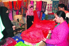 Women take a look at suits at a Pakistani stall at PITEX-2013 in Amritsar on Saturday