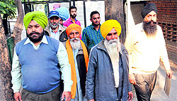 Villagers arrive at Sector 9, Chandigarh, to check the poll symbols for the Panchayat elections on Saturday