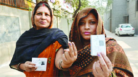 Women after casting their votes at ward No. 42, Jangpura Assembly constituency in New Delhi on Saturday.