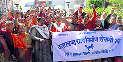 Members of the Uttarakhand Rajya Nirman Senani Manch hold a demonstration in support of their demands in Dehradun on Saturday