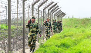 BSF men patrol International Border in RS Pura sector of Jammu district. Enemy fire and wild growth are a major challenge to the force.
