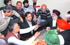 Industrialists argue with Punjab Local Bodies Minister Anil Joshi over the issue of rationalising property tax for commercial buildings in Jalandhar on Saturday. 