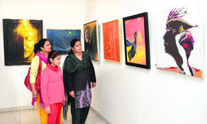 Art lovers view works of various artists during an exhibition organised by the Chandigarh Art College Old Students Association in Jalandhar on Saturday.