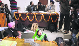Akali councillor Tanvir Singh Dhaliwal (sporting a pink turban) protests during the MC General House meeting in Ludhiana on December 6.