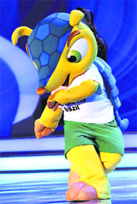 World Cup mascot Fuleco dances on stage during the draw for the 2014 World Cup in Sao Joao da Mata, Brazil.