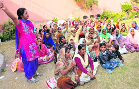 Mid-day meal workers raise slogans against the Punjab Government during a meeting in Bathinda on Sunday.