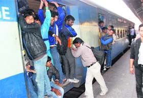 Aspirants board a train at the Chandigarh railway station on Sunday
