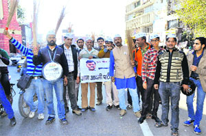 Members of the Aam Aadmi Party celebrate the partys success in the Delhi Assembly polls in Dehradun on Sunday.