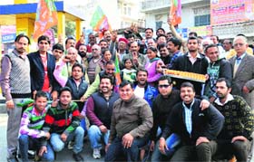 BJP state president Satpal Singh, along with party workers, celebrates the party victory in Una on Sunday