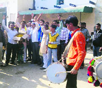 People celebrate Arvind Kejriwals electoral victory in Delhi at Siwani Mandi (Bhiwani) on Sunday.